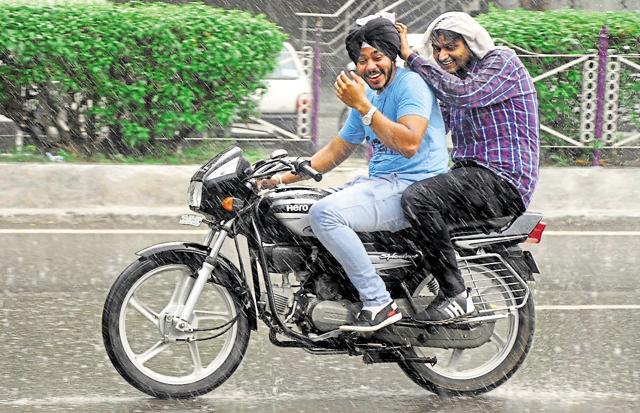 Ludhiana residents enjoying the rain on Friday. (JS Grewal/HT Photo)