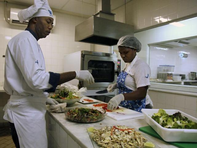 Cooks prepare meals during one of the many food-testing exercises for the Olympic menu in Rio. The have been working on special meals for participant athletes of certain sports, who are supposed to have a diet rich in calories , several times more than what the typical adult needs to get through a regular day. (AP) Cooks prepare meals during one of the many food-testing exercises for the Olympic menu in Rio. The have been working on special meals for participant athletes of certain sports, who are supposed to have a diet rich in calories , several times more than what the typical adult needs to get through a regular day. (AP)