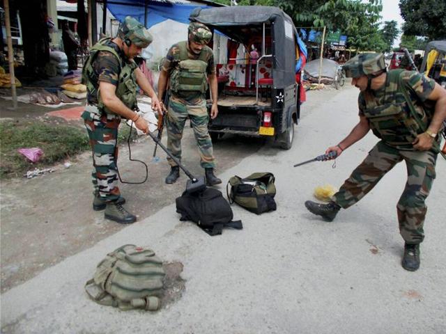 The army scrutinizes bags with metal detector recovered from suspected NDFB (S) militants who fired in a market area at Balajan Tinali near Kokrajhar town on Friday.(PTI) The army scrutinizes bags with metal detector recovered from suspected NDFB (S) militants who fired in a market area at Balajan Tinali near Kokrajhar town on Friday.(PTI)