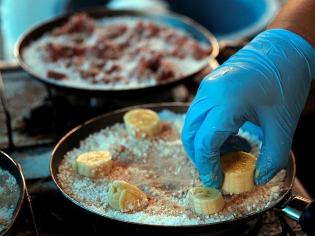 As expected, a lot of focus is on the traditional Brazilian cuisine, making good use of the opportunity to introduce the world to the food habits of the South Americans. Here, a woman prepares a tapioca dish, which is essentially unique Brazilian-style crepes. (REUTERS) As expected, a lot of focus is on the traditional Brazilian cuisine, making good use of the opportunity to introduce the world to the food habits of the South Americans. Here, a woman prepares a tapioca dish, which is essentially unique Brazilian-style crepes. (REUTERS)