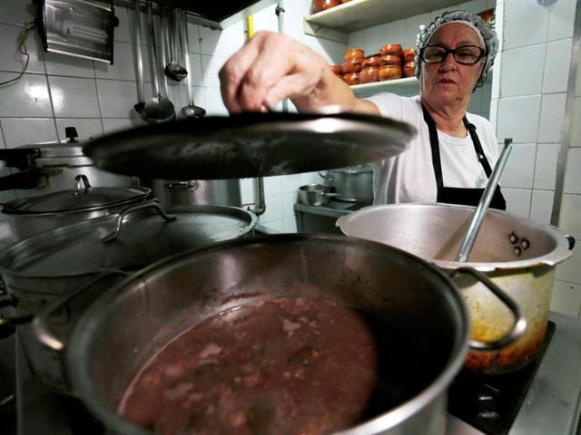 Brazilian dish feijoada being cooked at the Bar do Mineiro in Rio. Widely considered Brazil’s national dish, feijoada is a rich, deep, black bean stew slow cooked with meats like salted pork, smoked sausage, bacon, pork trimmings, or aged, dried beef. (REUTERS) Brazilian dish feijoada being cooked at the Bar do Mineiro in Rio. Widely considered Brazil’s national dish, feijoada is a rich, deep, black bean stew slow cooked with meats like salted pork, smoked sausage, bacon, pork trimmings, or aged, dried beef. (REUTERS)