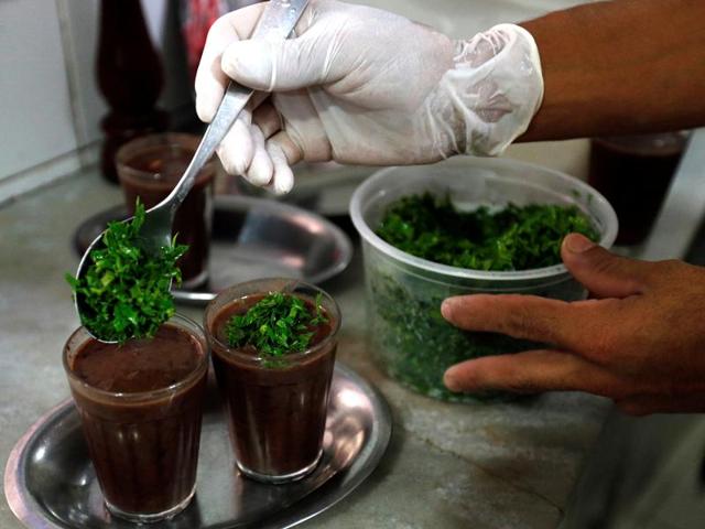 A man prepares a soup of beans to serve with feijoada. In Rio, the dish is considered as the Brazilian equivalent of England’s Sunday roast dinner, and is traditionally eaten during a leisurely, drawn out Saturday afternoon. (REUTERS) A man prepares a soup of beans to serve with feijoada. In Rio, the dish is considered as the Brazilian equivalent of England’s Sunday roast dinner, and is traditionally eaten during a leisurely, drawn out Saturday afternoon. (REUTERS)