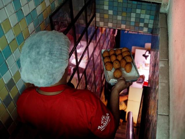 A woman prepares bolhinhos de bacalhau, or fried codfish balls, known to be the most famous Rio de Janeiro bar food. However, it’s said that a really sublime bolhinho, with the right mix of salt-cod, flour, potatoes and spice fried in the right oil, is hard to find. (REUTERS) A woman prepares bolhinhos de bacalhau, or fried codfish balls, known to be the most famous Rio de Janeiro bar food. However, it’s said that a really sublime bolhinho, with the right mix of salt-cod, flour, potatoes and spice fried in the right oil, is hard to find. (REUTERS)