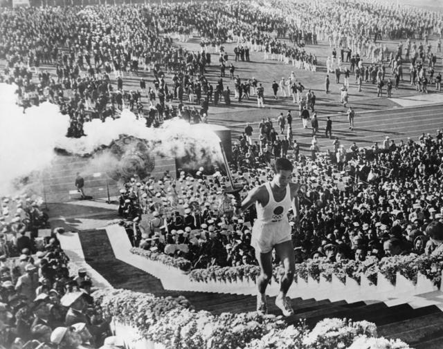 Olympic flame torchbearer Yoshinori Sakai mounts the steps to light the cauldron at the opening ceremony of the Summer Olympic Games at the National Olympic Stadium, Tokyo, 10th October 1964. (Getty Images) Olympic flame torchbearer Yoshinori Sakai mounts the steps to light the cauldron at the opening ceremony of the Summer Olympic Games at the National Olympic Stadium, Tokyo, 10th October 1964. (Getty Images)