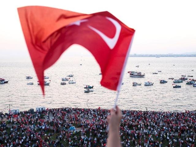 A man smokes a cigarette while fishing with others on Galata bridge in Istanbul on Thursday.(AP) A man smokes a cigarette while fishing with others on Galata bridge in Istanbul on Thursday.(AP)
