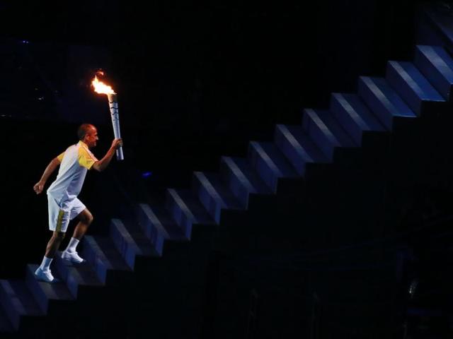 Vanderlei Cordeiro de Lima prepares to light the Olympic flame during the opening ceremony. (Reuters Photo)