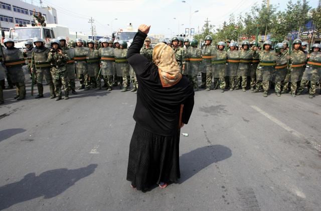 A local woman shouts at Chinese paramilitary police wearing riot gear as a crowd of angry locals confront security forces on a street in the city of Urumqi in China’s Xinjiang Autonomous Region. (Reuters File) A local woman shouts at Chinese paramilitary police wearing riot gear as a crowd of angry locals confront security forces on a street in the city of Urumqi in China’s Xinjiang Autonomous Region. (Reuters File)