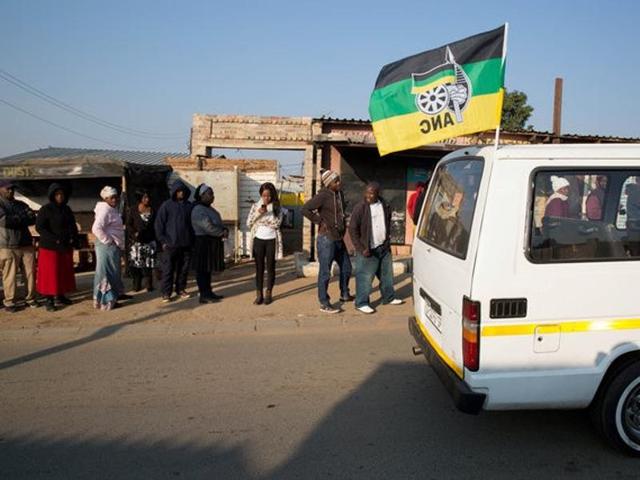 A taxi carrying the flag of the ruling African National Congress (ANC) party drives past locals queueing to cast their votes during the Local Government elections in Diepsloot township, north of Johannesburg, South Africa. (Reuters) A taxi carrying the flag of the ruling African National Congress (ANC) party drives past locals queueing to cast their votes during the Local Government elections in Diepsloot township, north of Johannesburg, South Africa. (Reuters)