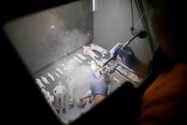 An employee cleans a 3D-printed figure. (REUTERS) An employee cleans a 3D-printed figure. (REUTERS)