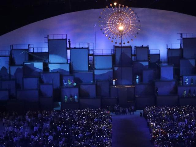 Brazilian marathoner Vanderlei de Lima lights the Olympic flame. (AP Photo)