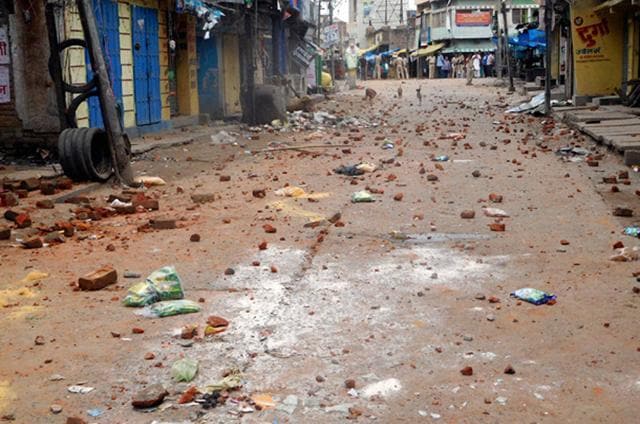Brick pices spread on the road after clashes between two communities in Saran district of Bihar on Saturday. (PTi) Brick pices spread on the road after clashes between two communities in Saran district of Bihar on Saturday. (PTi)
