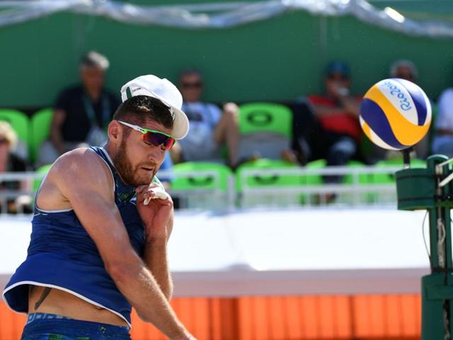 Brazil's Alison Cerutti spikes the ball during the men's beach volleyball qualifying match between Brazil and Canada. Hosts Brazil, a traditional superpower in the sport, won 21-19, 22-20. (AFP)