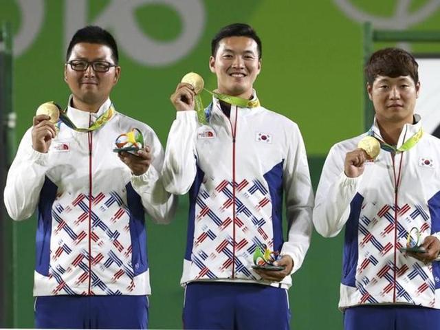 South Korea's Kim Woo-Jin , Ku Bon-Chan and Lee Seung-Yun pose on the podium after winning the men’s team gold medal in Archery. (REUTERS) South Korea's Kim Woo-Jin , Ku Bon-Chan and Lee Seung-Yun pose on the podium after winning the men’s team gold medal in Archery. (REUTERS)