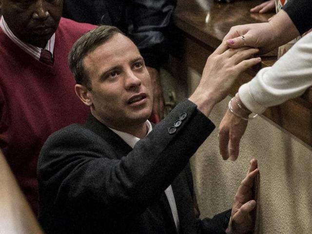 Oscar Pistorius covers his face with his hands as he listens to cross questioning about the events surrounding the shooting death of his girlfriend Reeva Steenkamp, in court during his trial in Pretoria.(AP File Photo)