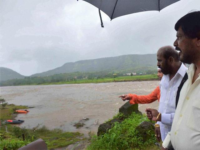 Minister of state for social justice and empowerment Ramdas Athawale visiting Mahad-Poladpur bridge which was washed away by the flood waters of Savitri river on the Mumbai-Goa highway near Mahad in Raigad district on Saturday. (PTI) Minister of state for social justice and empowerment Ramdas Athawale visiting Mahad-Poladpur bridge which was washed away by the flood waters of Savitri river on the Mumbai-Goa highway near Mahad in Raigad district on Saturday. (PTI)