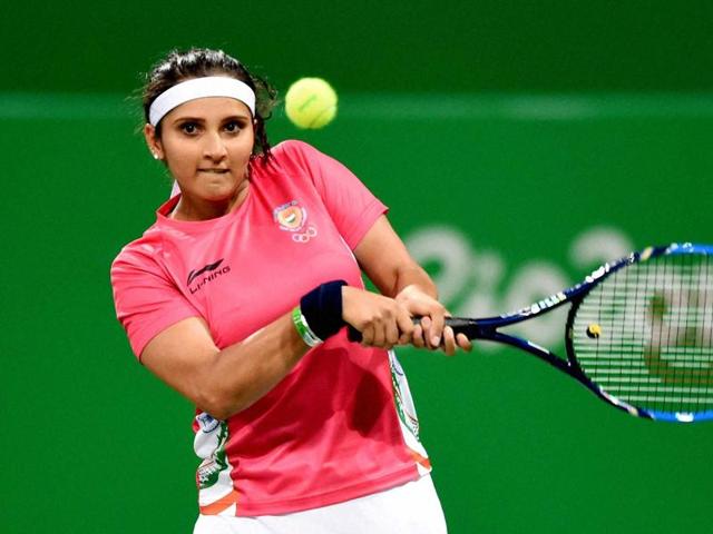 India's Sania Mirza plays a shot during a mixed doubles qualifying round with China. (PTI Photo) India's Sania Mirza plays a shot during a mixed doubles qualifying round with China. (PTI Photo)