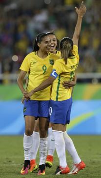 Brazil's Marta, right, celebrates scoring her side's third goal against Sweden. (AP)