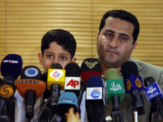 In this file photo, Iranian nuclear scientist Shahram Amiri attends a news briefing while holding his son Amir Hossein as he arrives at the Imam Khomeini airport just outside Tehran. (AP) In this file photo, Iranian nuclear scientist Shahram Amiri attends a news briefing while holding his son Amir Hossein as he arrives at the Imam Khomeini airport just outside Tehran. (AP)