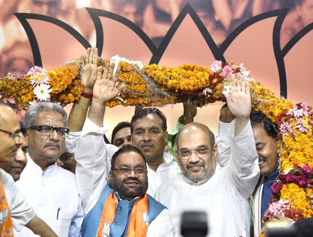 Former BSP Leader Swami Prasad Maurya (in blue vest) being welcomed by BJP President Amit Shah after he joined Bharatiya janta Party in New Delhi on August 8, 2016. (Arvind Yadav / HT Photo) Former BSP Leader Swami Prasad Maurya (in blue vest) being welcomed by BJP President Amit Shah after he joined Bharatiya janta Party in New Delhi on August 8, 2016. (Arvind Yadav / HT Photo)