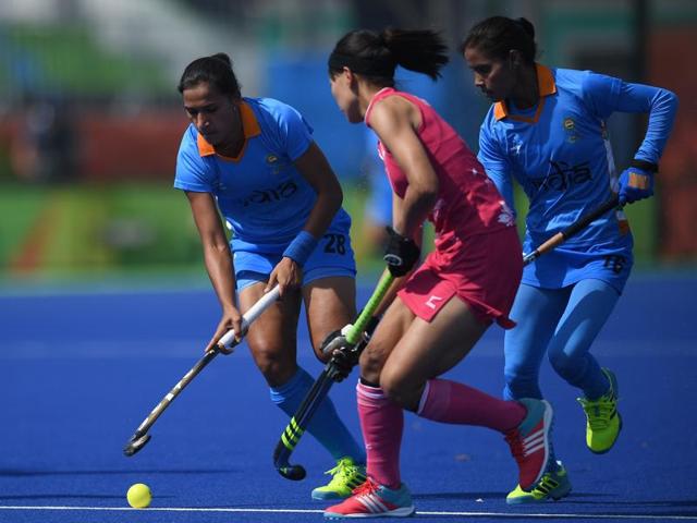 India's Rani (L) fights for the ball with Japan's Ayaka Nishimura (C) as India's Vandana Katariya looks on during the women's field hockey Japan vs India match. (AFP Photo) India's Rani (L) fights for the ball with Japan's Ayaka Nishimura (C) as India's Vandana Katariya looks on during the women's field hockey Japan vs India match. (AFP Photo)