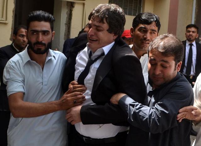 Pakistani men comfort a lawyer after the death of his colleagues in a suicide attack at the Civil Hospital in Quetta on Monday. (AFP) Pakistani men comfort a lawyer after the death of his colleagues in a suicide attack at the Civil Hospital in Quetta on Monday. (AFP)