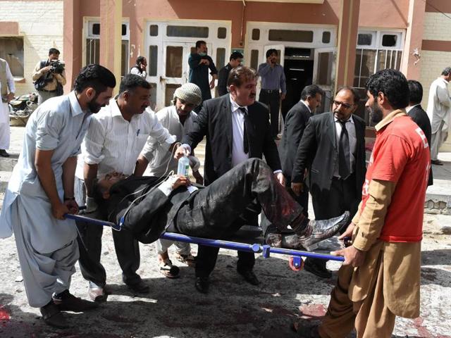Pakistani lawyers use a stretcher to move an injured colleague after the explosion. Over 100 were injured in the attack. (AFP) Pakistani lawyers use a stretcher to move an injured colleague after the explosion. Over 100 were injured in the attack. (AFP)