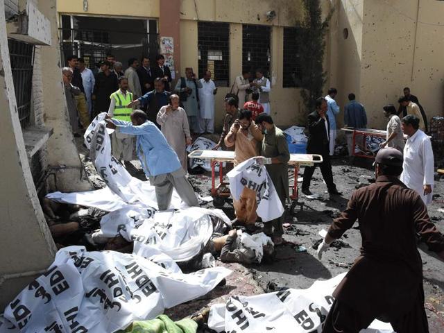 Pakistani volunteers cover the bodies of victims after the bomb explosion at a government hospital premises in Quetta (AFP) Pakistani volunteers cover the bodies of victims after the bomb explosion at a government hospital premises in Quetta (AFP)