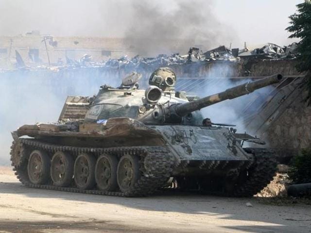 A Free Syrian Army fighter looks out of a tank in Ramousah area southwest of Aleppo, Syria August 2, 2016. REUTERS/Abdalrhman Ismail A Free Syrian Army fighter looks out of a tank in Ramousah area southwest of Aleppo, Syria August 2, 2016. REUTERS/Abdalrhman Ismail