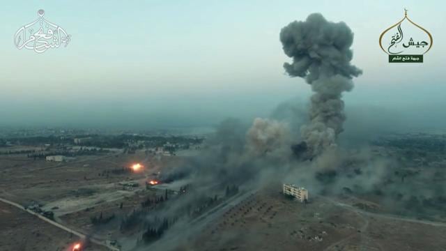 An image grab taken from a video released on Saturday by Fateh al-Sham Front, the former Al-Nusra Front, which renamed itself after renouncing its status as Al-Qaeda's Syrian affiliate, shows a still from drone footage of smoke billowing from an artillery school south of Aleppo as Islamist rebels captured two military academies and a third military position. (AFP) An image grab taken from a video released on Saturday by Fateh al-Sham Front, the former Al-Nusra Front, which renamed itself after renouncing its status as Al-Qaeda's Syrian affiliate, shows a still from drone footage of smoke billowing from an artillery school south of Aleppo as Islamist rebels captured two military academies and a third military position. (AFP)