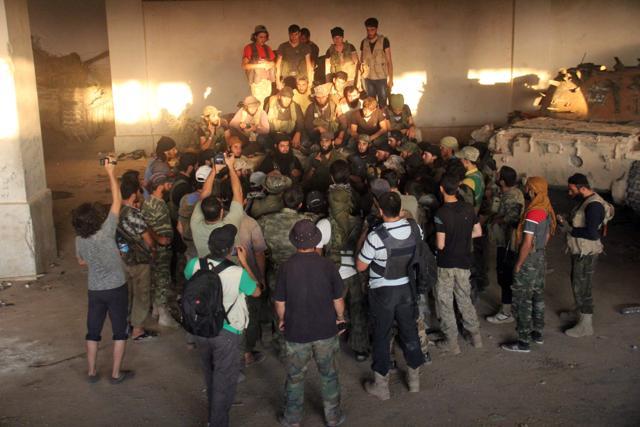 Opposition fighters listen to a speech at an armament school after they recaptured the military facility south of Aleppo on Friday, the Syrian Observatory for Human Rights said. (AFP) Opposition fighters listen to a speech at an armament school after they recaptured the military facility south of Aleppo on Friday, the Syrian Observatory for Human Rights said. (AFP)