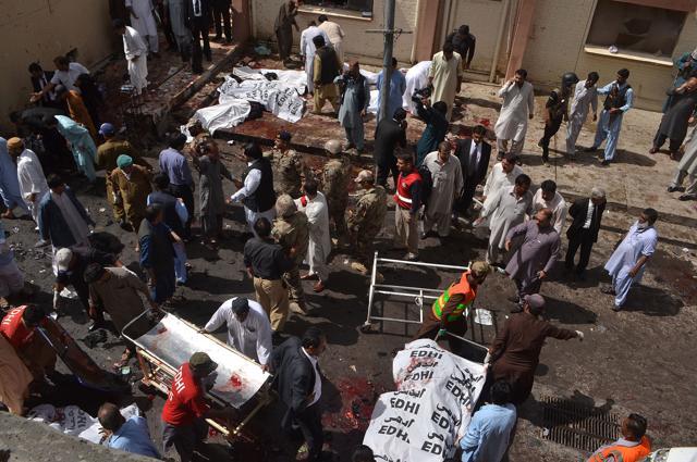 Pakistani security officials and lawyers gather around the bodies of victims killed in a suicide attack at the Civil Hospital in Quetta on Monday. (AFP) Pakistani security officials and lawyers gather around the bodies of victims killed in a suicide attack at the Civil Hospital in Quetta on Monday. (AFP)