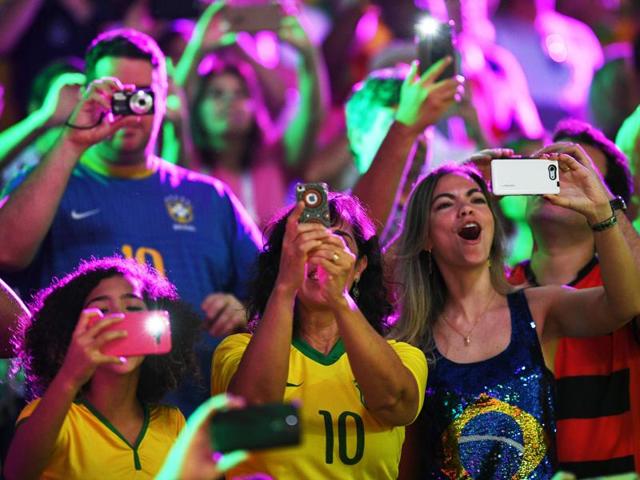 Supporters take pictures as they cheer for their team during the men's qualifying volleyball match between Brazil and Mexico at the Maracanazinho stadium. (AFP Photo) Supporters take pictures as they cheer for their team during the men's qualifying volleyball match between Brazil and Mexico at the Maracanazinho stadium. (AFP Photo)