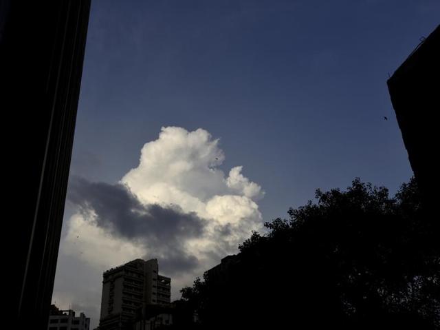 ‘Cotton balls’: Monsoon clouds, white as milk, hover over the skies of national capital on Monday. The evening silhouette adds a perfect contrast. (Virendra Singh Gosain/HT Photo)
