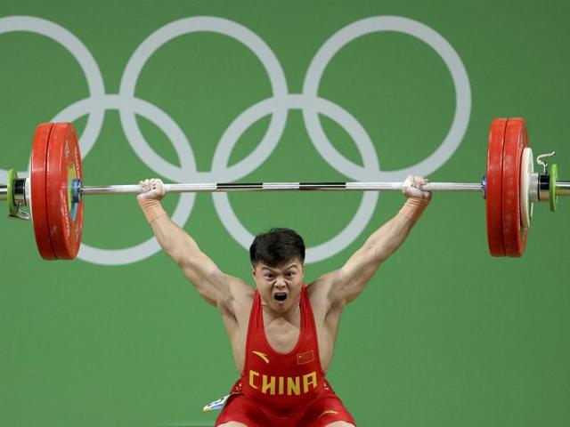 Long Qingquan of China set a world record in winning Olympic gold in the men’s weightlifting 53-kilogram category Sunday. (REUTERS) Long Qingquan of China set a world record in winning Olympic gold in the men’s weightlifting 53-kilogram category Sunday. (REUTERS)