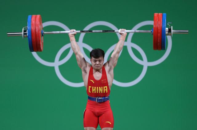 Long Qingquan of China won the men's 56kg weightlifting gold with a world record attempt. (Lars Baron/Getty Images)