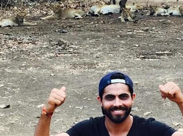 A photo shared by Jadeja on Instagram showed him pointing at the lions in the background at Gir Wildlife Sanctuary at Sasan in Junagadh. (Instagram) A photo shared by Jadeja on Instagram showed him pointing at the lions in the background at Gir Wildlife Sanctuary at Sasan in Junagadh. (Instagram)