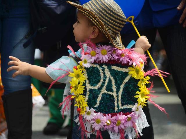 A young ‘silleterito’ goes with the flow of the festival. (AFP) A young ‘silleterito’ goes with the flow of the festival. (AFP)
