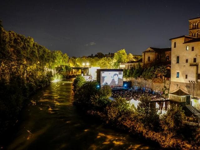 People attend a movie in an open air cinema on the Tiber Island in downtown Rome. (AFP) People attend a movie in an open air cinema on the Tiber Island in downtown Rome. (AFP)