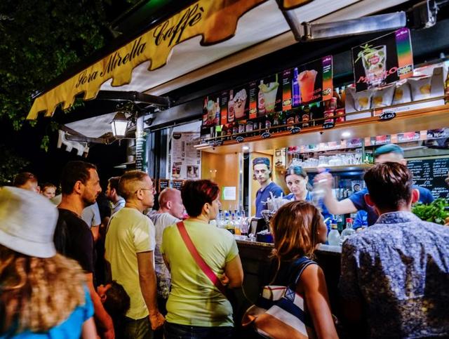 People queue in front of a kiosk to buy a "Grattachecca" (slush ice). (AFP) People queue in front of a kiosk to buy a "Grattachecca" (slush ice). (AFP)