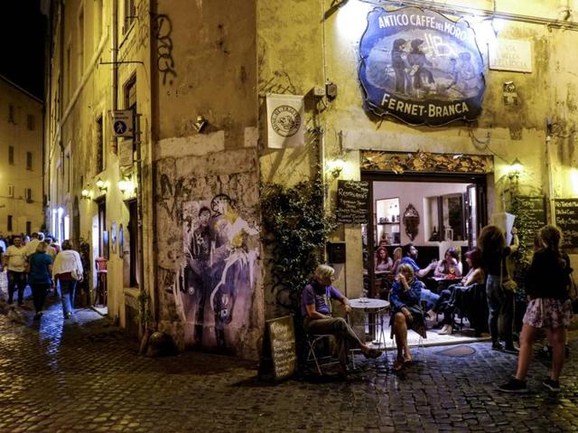 People sit outside a cafe in the district of Trastevere. The gorgeous lights and the lively atmosphere is perfect for a long walk at night. (AFP) People sit outside a cafe in the district of Trastevere. The gorgeous lights and the lively atmosphere is perfect for a long walk at night. (AFP)