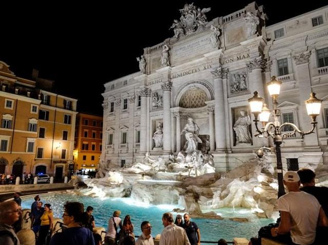 People sit around the Trevi Fountain, downtown Rome. (AFP) People sit around the Trevi Fountain, downtown Rome. (AFP)
