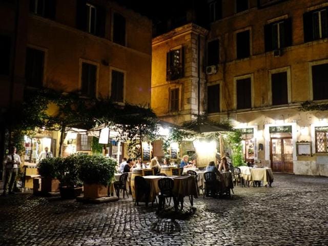 People sit on a terrace of a restaurant in the district of Trastevere. (AFP) People sit on a terrace of a restaurant in the district of Trastevere. (AFP)
