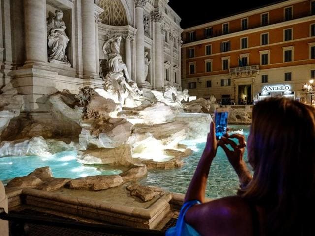 A woman takes a picture of the Trevi Fountain. (AFP) A woman takes a picture of the Trevi Fountain. (AFP)