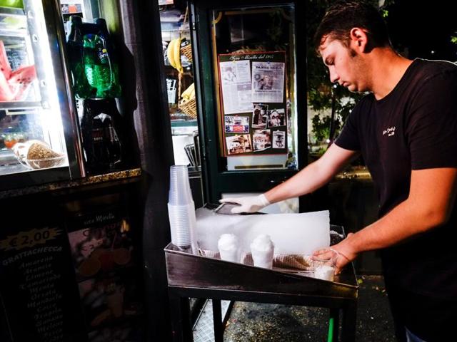 A vendor prepares a "Grattachecca" (slush ice), in downtown Rome. (AFP) A vendor prepares a "Grattachecca" (slush ice), in downtown Rome. (AFP)