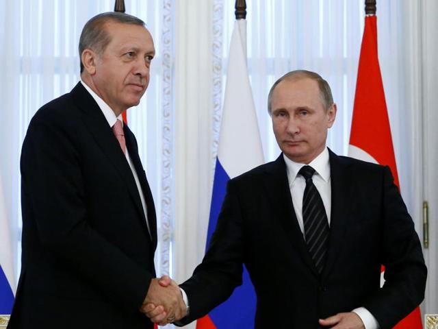 Russian President Vladimir Putin shakes hands with Turkish President Tayyip Erdogan during a news conference following their meeting in St. Petersburg, Russia on Tuesday.(Reuters)
