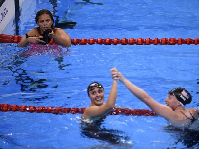 Russia's Yulia Efimova looks on as King and Meili celebrate after the finish of 100m breaststroke final. (AFP photo)