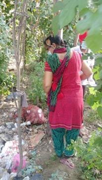 Forensic experts inspecting the plot which is used as a dumping ground in the area. (HT Photo)