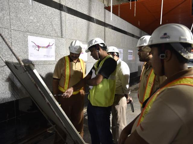 Workers  study a  construction plan at the Delhi Gate Metro Station. When the Metro’s heritage line from ITO to Kashmere Gate opens in November, it will provide the ideal opportunity to explore the Walled City. (AJay Aggarwal/HT PHOTO) 
