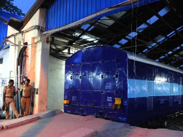 Police personnel stand guard alongside the Salem-Chennai Express train, which was robbed while in transit, at Egmore Railway station in Chennai on August 9.(AFP)