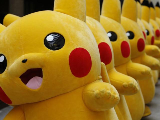 A woman walks by giant toys of Pokemon character Pikachu at a shopping district during a special gathering event in Yokohama on Wednesday. (AP) A woman walks by giant toys of Pokemon character Pikachu at a shopping district during a special gathering event in Yokohama on Wednesday. (AP)